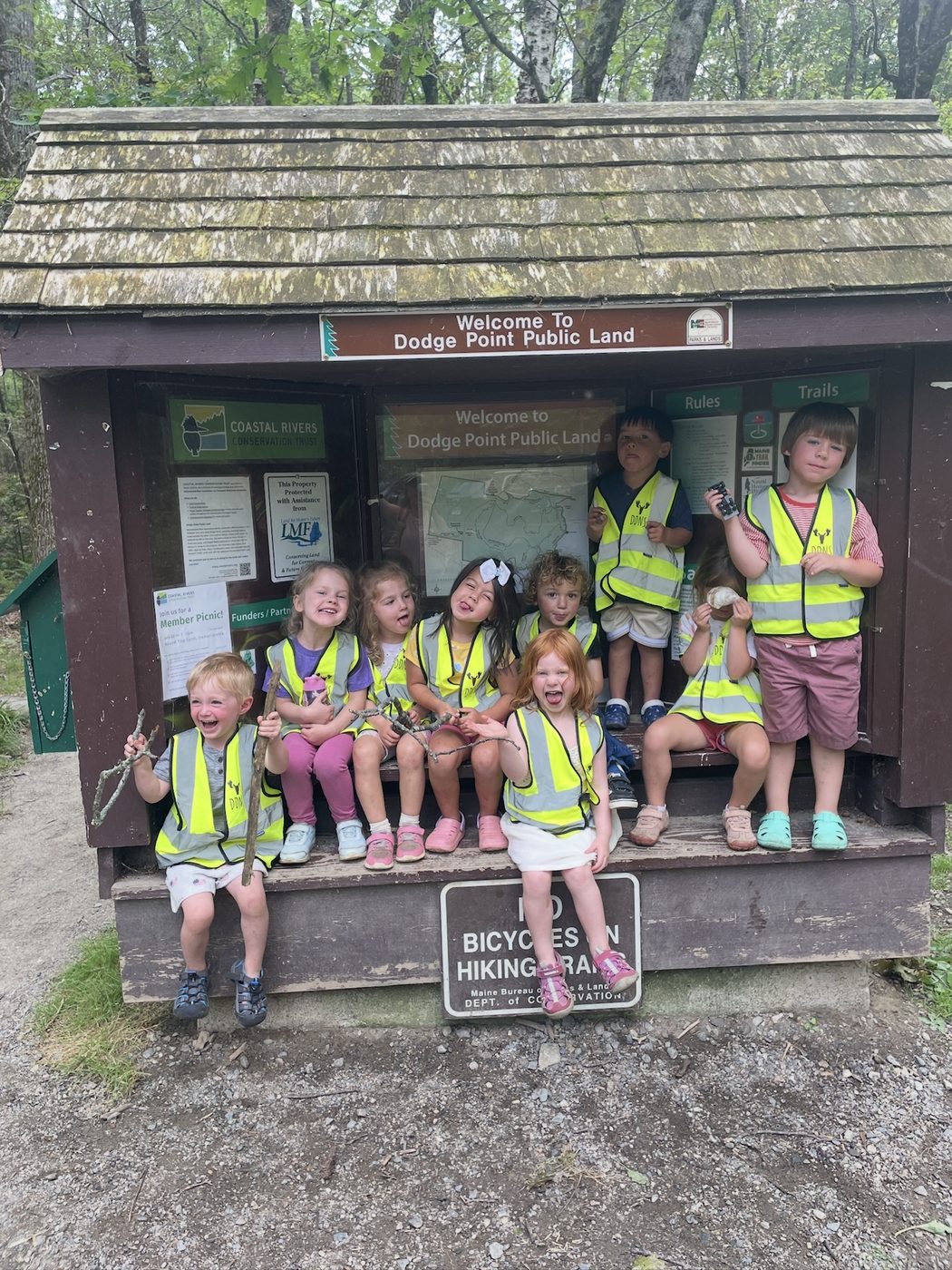 The class laughs together at the Dodge Point trailhead kiosk